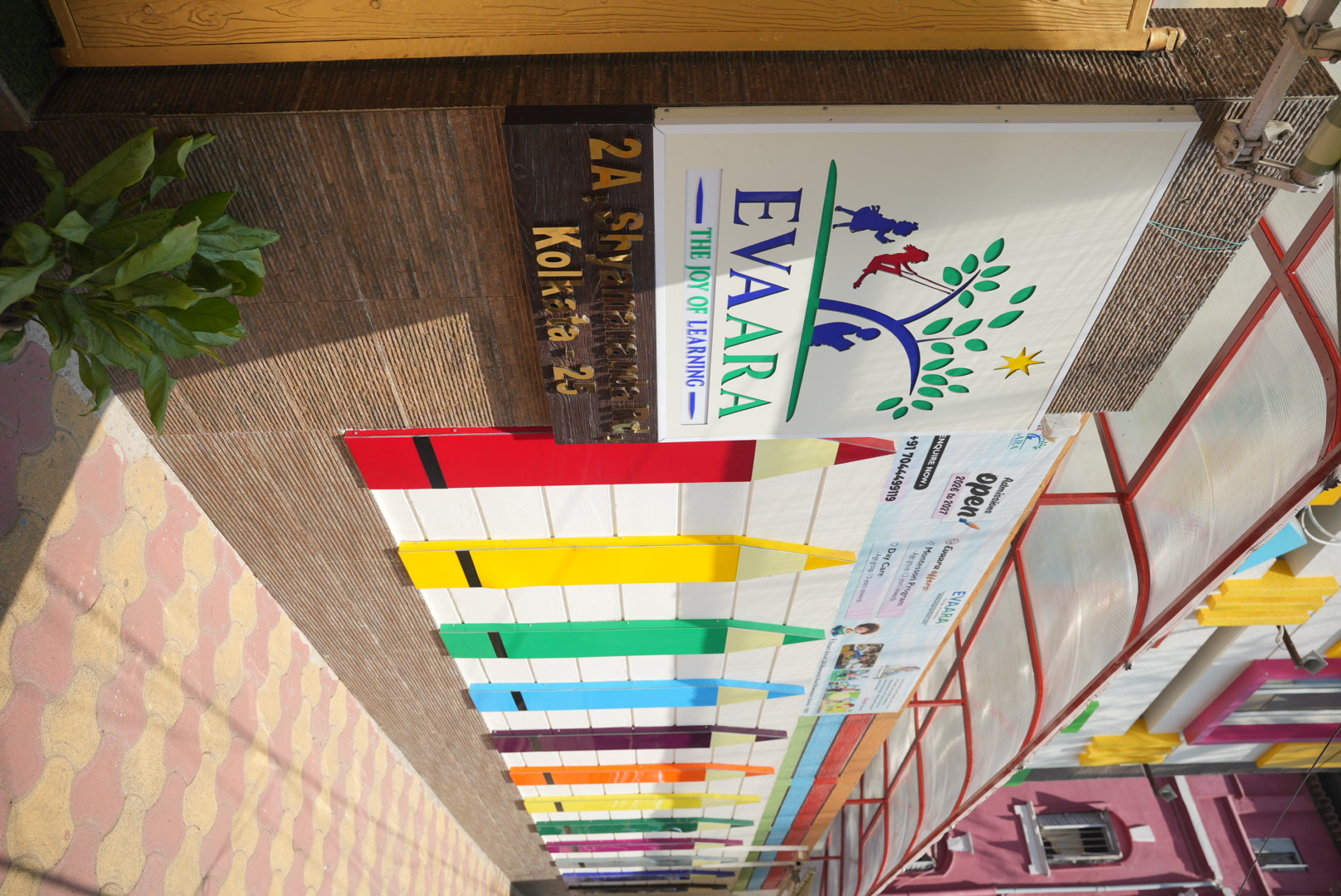 Evaara School entrance with colorful gate and The Joy of Learning signage, Kolkata