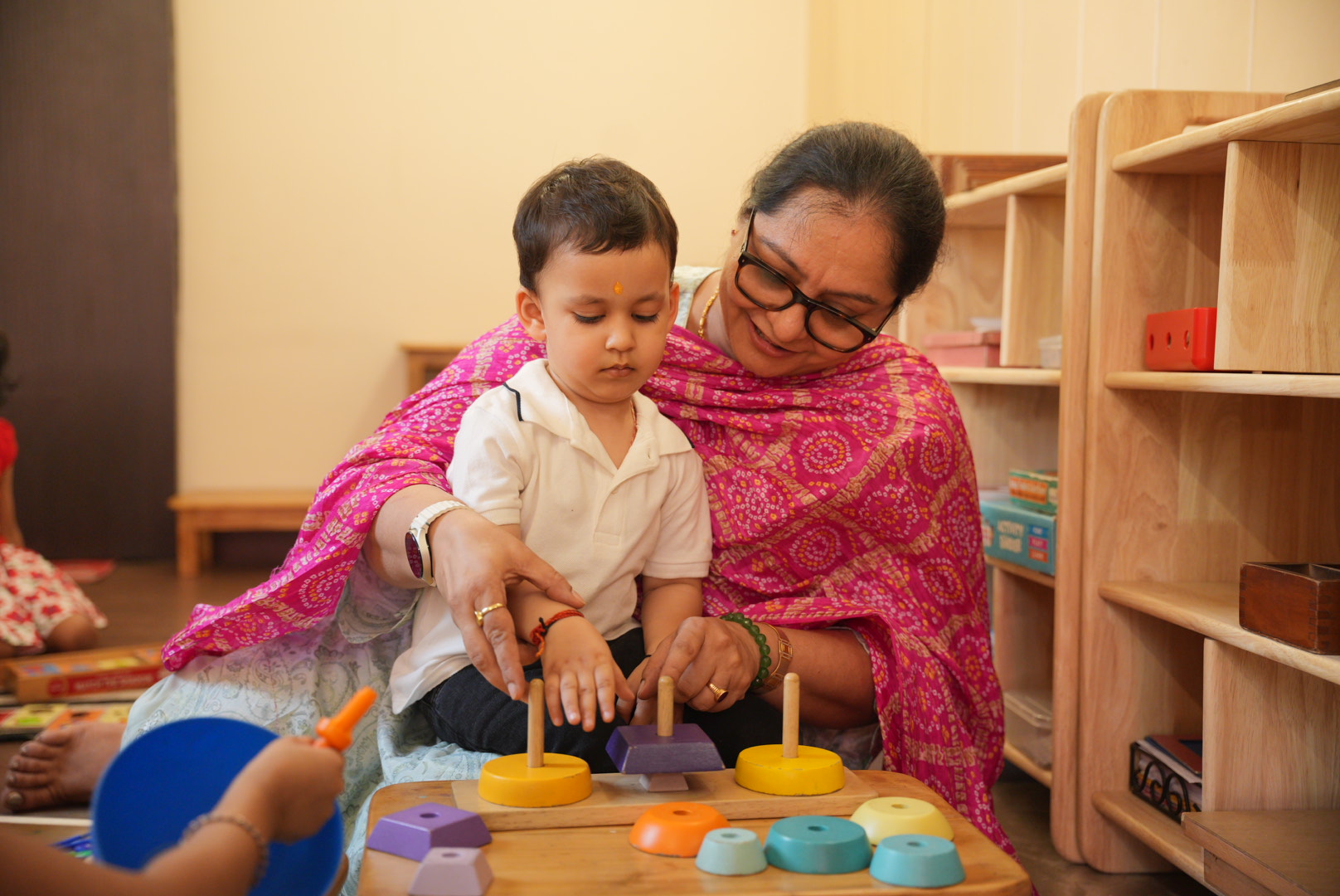 Young children and an educator in a gentle classroom moment