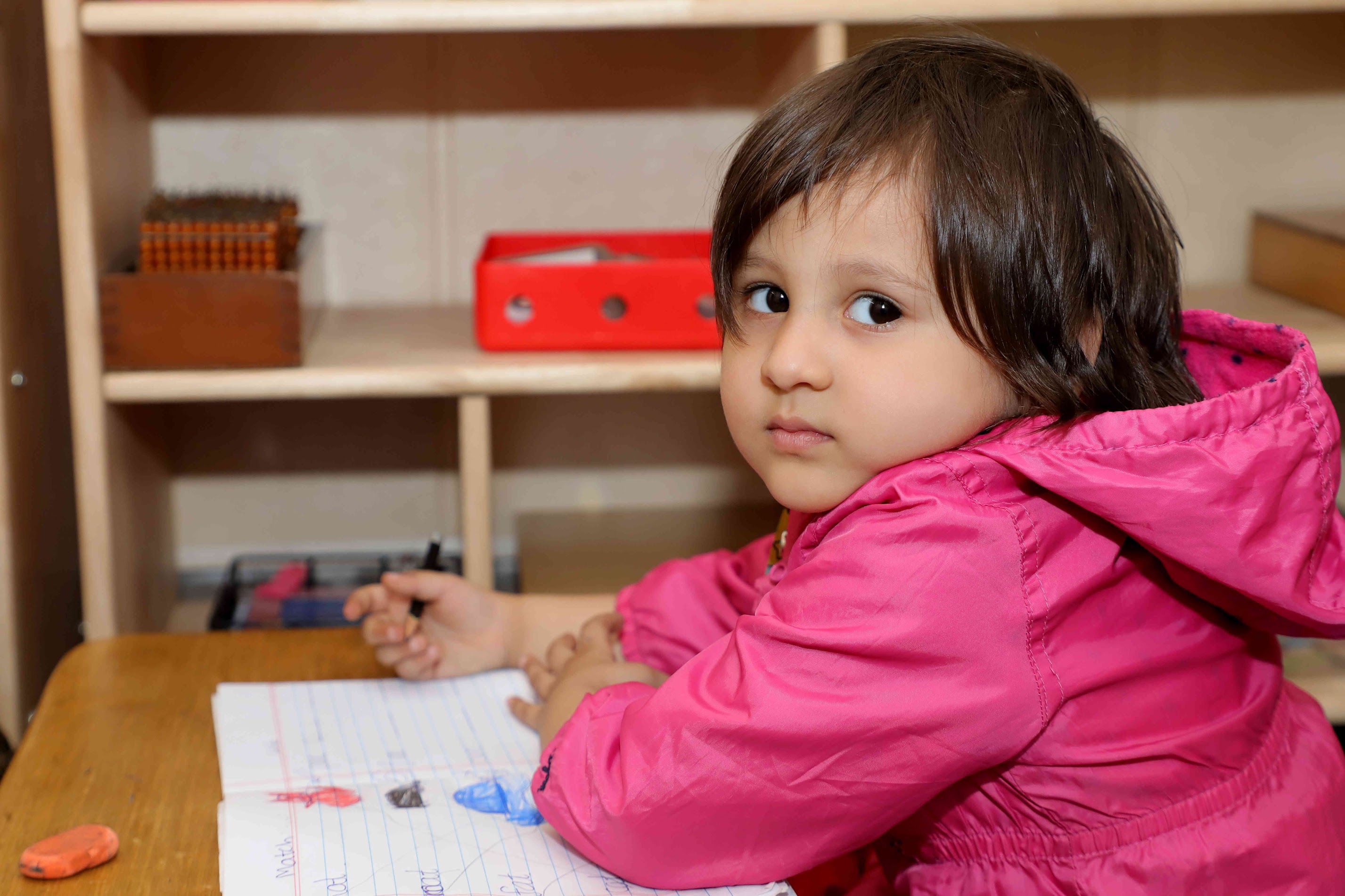Child engaged with Montessori materials at Evaara